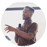 image of yound black man speaking to a crowd with a microphone | The Gulf Coast Sexual Assault Program provides services to victims of sexual violence in Bay, Gulf, Calhoun, Jackson, Washington, Santa Rosa, Escambia, Okaloosa, Walton and Holmes Counties